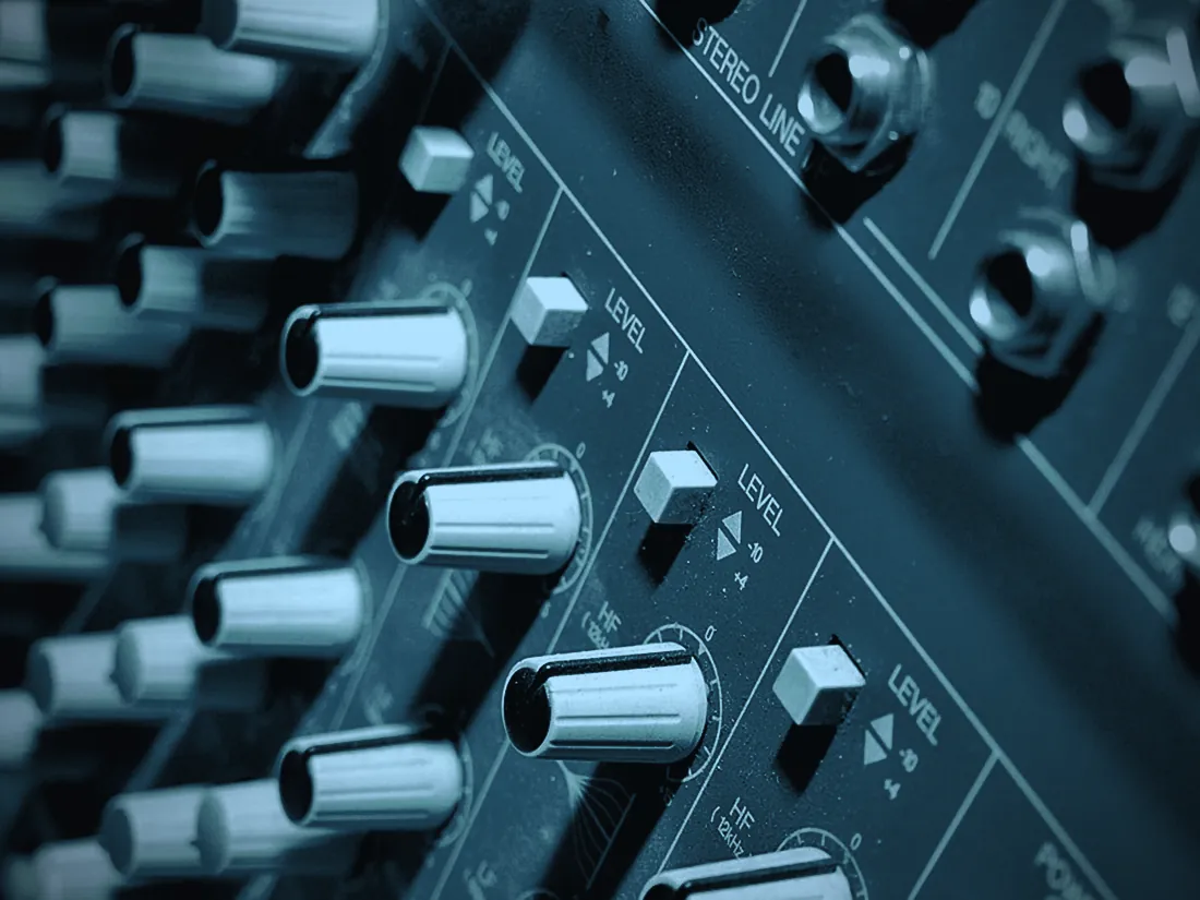 A mixing console, lit from the side